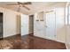 Bedroom with damaged hardwood floors, peeling paint, and interior doors at 1603 Doreen Ave, Ocoee, FL 34761