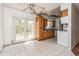 A dated kitchen featuring a stained ceiling, damaged drywall, French doors, and tile flooring at 1603 Doreen Ave, Ocoee, FL 34761