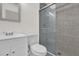 Modern bathroom featuring a glass-enclosed shower, tile surround, updated vanity, and fixtures at 2341 Hadley St, Deltona, FL 32738