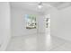 Bright bedroom with tiled floors, ceiling fan, and natural light at 2341 Hadley St, Deltona, FL 32738