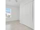 Bedroom with tile flooring, large window, and closet access at 2341 Hadley St, Deltona, FL 32738