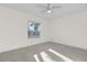 Spacious bedroom with ceiling fan and large window at 2341 Hadley St, Deltona, FL 32738