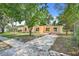A quaint single-Gathering home featuring a simple design and a spacious driveway for easy parking at 2341 Hadley St, Deltona, FL 32738