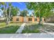 Charming single-story home with a well-manicured lawn and mature trees providing ample shade at 2341 Hadley St, Deltona, FL 32738
