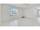 Bright, airy living room with large window, tiled floors, and neutral color palette at 2341 Hadley St, Deltona, FL 32738