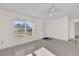 Bright and airy living room featuring tile floors and a ceiling fan at 2341 Hadley St, Deltona, FL 32738