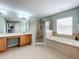 Spa-like bathroom with double vanity, soaking tub, and walk-in shower at 2510 Black Lake Blvd, Winter Garden, FL 34787