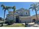 Charming two-story home featuring a well-manicured lawn and mature palm trees at 2510 Black Lake Blvd, Winter Garden, FL 34787