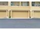 Exterior view of townhomes featuring attached garages, private balconies, and well-maintained landscaping at 607 Pensacola Ln, Lake Mary, FL 32746
