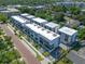 Aerial view of modern townhouses with flat roofs, showcasing a brick street and lush landscaping at 66 W Harding St # B, Orlando, FL 32806