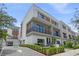 Contemporary townhouse with driveway and manicured hedges at 66 W Harding St # B, Orlando, FL 32806