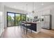 Modern kitchen with island, stainless steel appliances, and balcony view at 66 W Harding St # B, Orlando, FL 32806