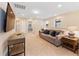 Spacious bonus room featuring a comfy couch and large TV, perfect for entertainment at 8851 Geneve Ct, Kissimmee, FL 34747