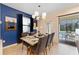 Bright dining room with a wood table and access to the patio at 8851 Geneve Ct, Kissimmee, FL 34747