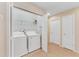 Convenient laundry room with washer, dryer, and shelving for storage at 8851 Geneve Ct, Kissimmee, FL 34747