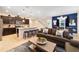 Open concept living room with gray sofas and kitchen view at 8851 Geneve Ct, Kissimmee, FL 34747