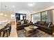 Open living space with gray sofas and view of the lanai at 8851 Geneve Ct, Kissimmee, FL 34747