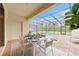 Inviting pool area with screened enclosure, dining table, and lounge chairs at 8851 Geneve Ct, Kissimmee, FL 34747
