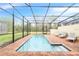 Relaxing screened-in pool with brick pavers and plenty of lounge space at 8851 Geneve Ct, Kissimmee, FL 34747