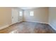 Spacious bedroom with wood-look floors and an exterior door at 1307 Pine Lake Rd, Orlando, FL 32808