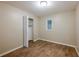 Bedroom with wood-look floors and a small window at 1307 Pine Lake Rd, Orlando, FL 32808