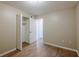 Spacious bedroom with wood-look floors and large closet at 1307 Pine Lake Rd, Orlando, FL 32808