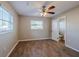 Bedroom with ceiling fan, wood-like floors, and window at 1307 Pine Lake Rd, Orlando, FL 32808