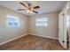 Bedroom with ceiling fan, wood-like floors, and window at 1307 Pine Lake Rd, Orlando, FL 32808