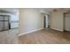 Open dining area with wood-look floors and adjacent kitchen at 1307 Pine Lake Rd, Orlando, FL 32808