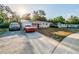 Newly renovated home with a driveway and a spacious front yard at 1307 Pine Lake Rd, Orlando, FL 32808