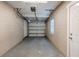 Attached garage with overhead storage and concrete floor at 1307 Pine Lake Rd, Orlando, FL 32808