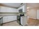 Modern kitchen with white cabinets, granite counters, and stainless steel appliances at 1307 Pine Lake Rd, Orlando, FL 32808