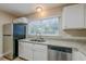 Modern kitchen with white cabinets, granite counters and stainless steel appliances at 1307 Pine Lake Rd, Orlando, FL 32808