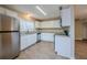 Modern kitchen with white cabinets, granite counters, and stainless steel appliances at 1307 Pine Lake Rd, Orlando, FL 32808