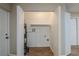 Bright laundry room with washer and dryer hookups, shelving and water heater at 1307 Pine Lake Rd, Orlando, FL 32808