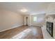 Living room with fireplace and wood-look floors at 1307 Pine Lake Rd, Orlando, FL 32808