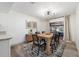 Bright dining area featuring a modern light fixture, art on the wall, and a wooden table set at 1422 Tierra Cir, Winter Park, FL 32792