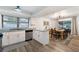 Open floor plan with wood-look floors connecting the dining area with backyard access and the kitchen at 1422 Tierra Cir, Winter Park, FL 32792
