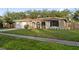 House exterior showcasing a well-maintained lawn and attached garage at 1422 Tierra Cir, Winter Park, FL 32792