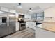 Kitchen with stainless steel refrigerator, granite counters, white cabinets, and stainless steel appliances at 1422 Tierra Cir, Winter Park, FL 32792