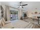 Spacious living room with a ceiling fan, backyard access and neutral decor at 1422 Tierra Cir, Winter Park, FL 32792