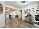 Open concept living space with wood floors seamlessly connecting the kitchen and dining area at 1422 Tierra Cir, Winter Park, FL 32792