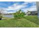 Backyard featuring a verdant lawn, shade tree, and peaceful lake view at 15155 Mayberry Dr, Winter Garden, FL 34787