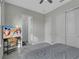 Bedroom showcasing a TV, closet, and view of the bedroom's neutral color palette at 15155 Mayberry Dr, Winter Garden, FL 34787