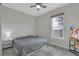 Cozy bedroom with a ceiling fan, neutral walls, and natural light from the window at 15155 Mayberry Dr, Winter Garden, FL 34787