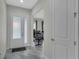 Bright foyer featuring modern tile flooring and a frosted glass front door leading to an office space at 15155 Mayberry Dr, Winter Garden, FL 34787