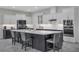 Modern kitchen features a large center island with seating, white cabinets, and stainless steel appliances at 15155 Mayberry Dr, Winter Garden, FL 34787