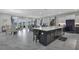 Open floor plan showcasing kitchen island, living room, and dining area with access to the backyard at 15155 Mayberry Dr, Winter Garden, FL 34787