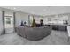 Well-lit open living area featuring a large sectional sofa, a kitchen, and a festive Christmas tree at 15155 Mayberry Dr, Winter Garden, FL 34787