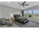 Spacious main bedroom with lake views and a cozy seating area at 15155 Mayberry Dr, Winter Garden, FL 34787